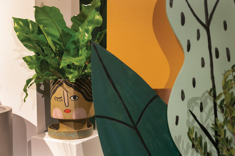 A close up image of an Accent Decor planter sitting within a showroom installation.