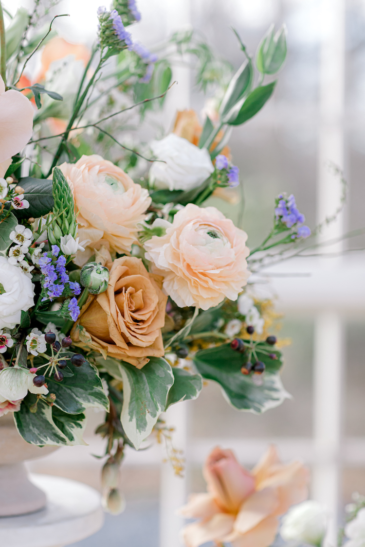 A close up shot of lush florals designed within an Accent Decor compote.