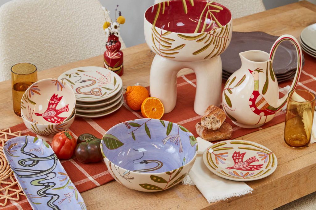 A table top showcasing a stunning and stylish collection of dinnerware. The table is elegantly set, featuring a range of carefully chosen plates, bowls, and cups.