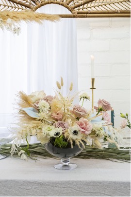 Limpid Compote containing a lush, stylish wedding centerpiece arrangement.