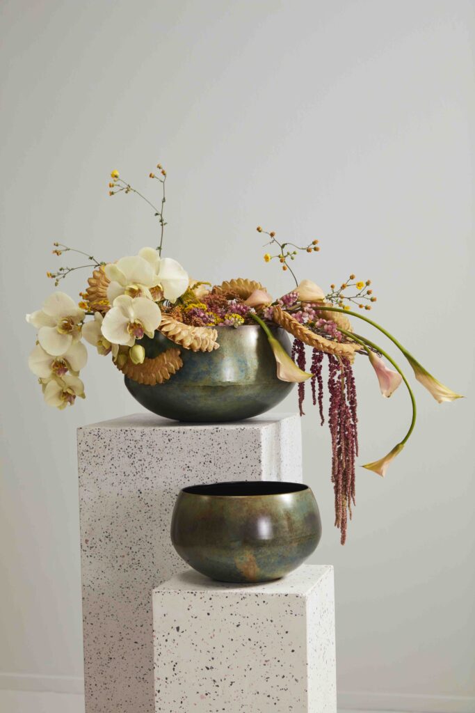 Accent Decor's Eco-Friendly Floral Sosa Bowl atop a white pedestal. 