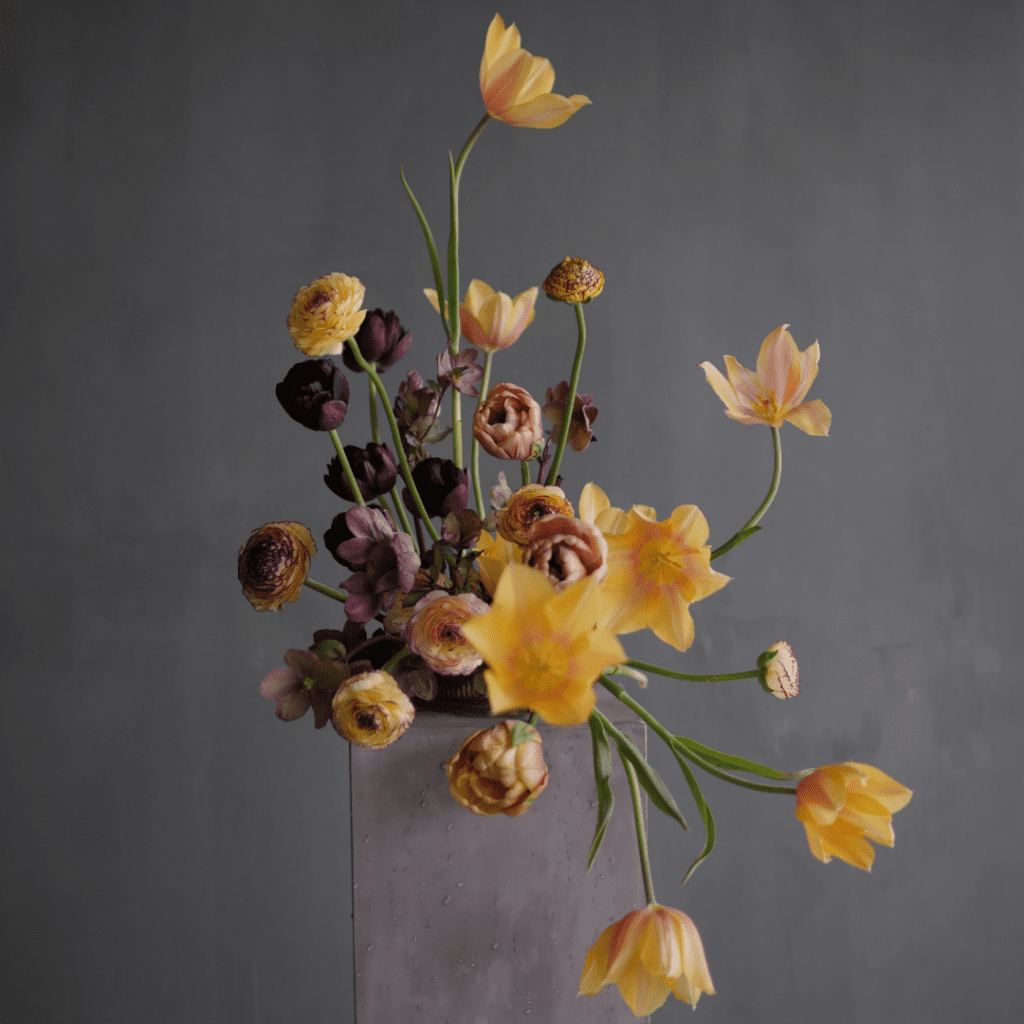 Image of a striking, large floral arrangement contained in a compote from wholesale floral decor supplier, Accent Decor.