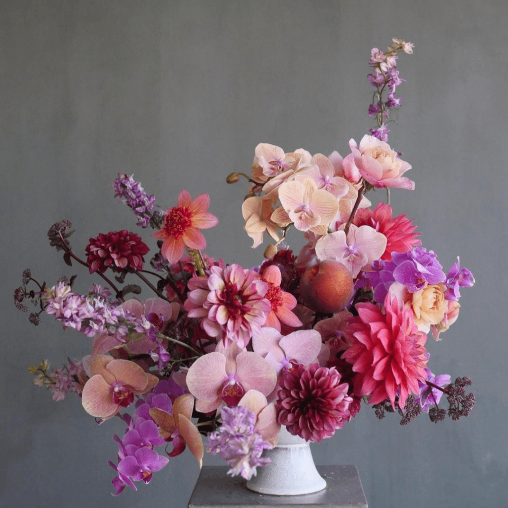 Image of a striking, large floral arrangement contained in a compote from wholesale floral decor supplier, Accent Decor.