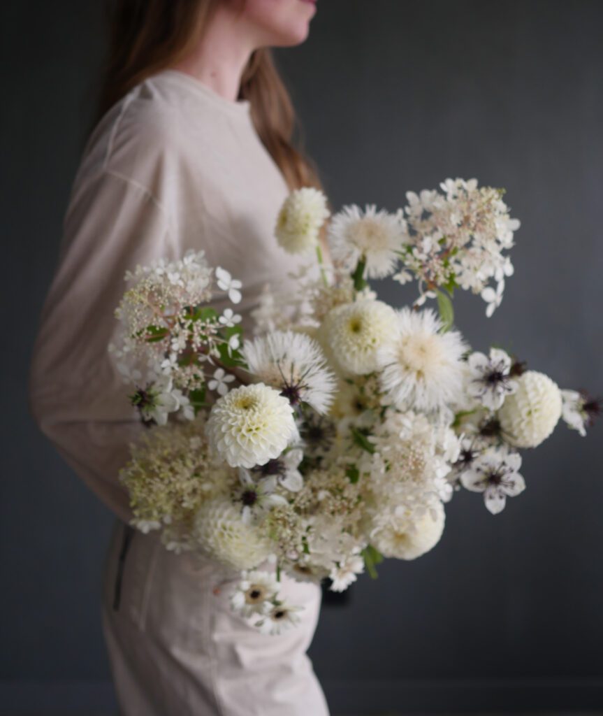 Image of a striking, large floral bouquet held by a woman.
