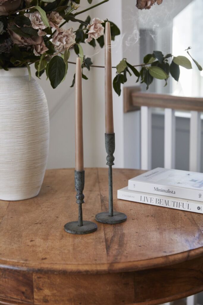 Image of the Barton Candlestick, a wholesale home accent from the wholesale decor supplier Accent Decor, displayed atop a table.