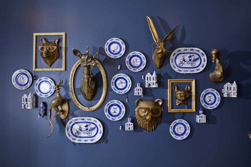 The E+E Wall Mounts mounted on a vibrant blue wall, styled with the E+E Dinner Plates.