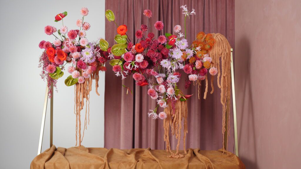 Accent Decor's Tenuto Stand, styled with lush & cascading flowers, atop a table.