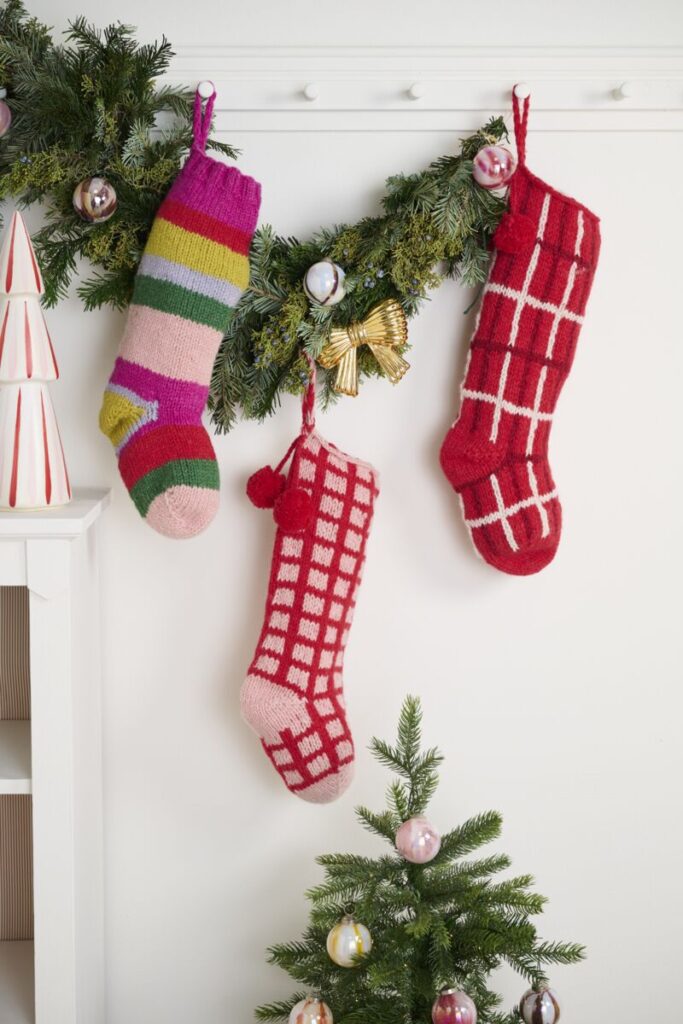 Accent Decor's Holiday Brights Stocking mounted on a mall near lush, green garland.