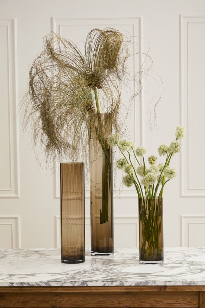 Accent Decor's Rune Vase, a large glass vase, artfully styled with florals atop a marble table.
