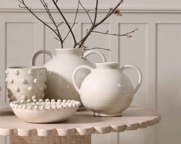 A variety of large vessels and bowls, each in a neutral cream hue with various knobby details.