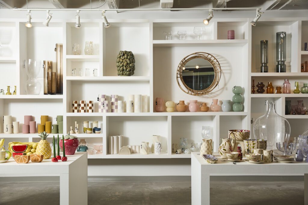 Image of colorful planter pots, vases & home decor on a variety of tables & shelves.