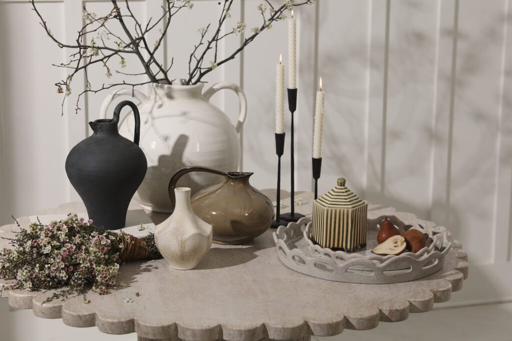 A scalloped tray atop a countertop with pears and cheese.