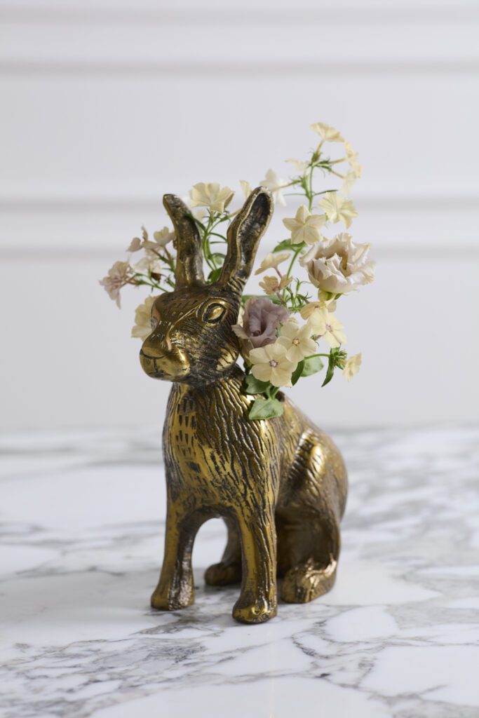 Cast aluminum bunny vase with dainty florals.