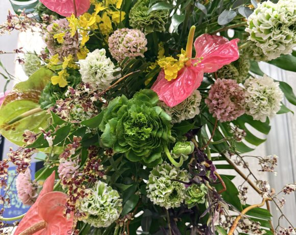Lush tropical florals in shades of green, yellow & red.