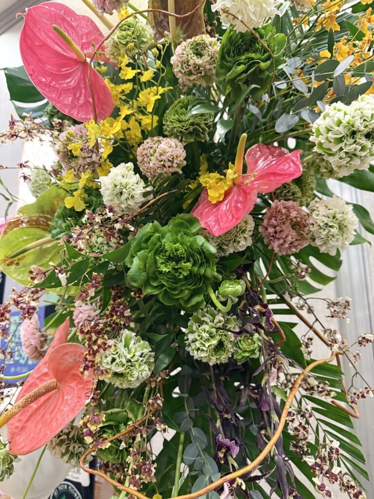 Lush tropical florals in shades of green, yellow & red.